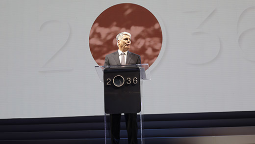 Emory President Gregory L. Fenves delivers a speech at a podium with the 2036 logo on it