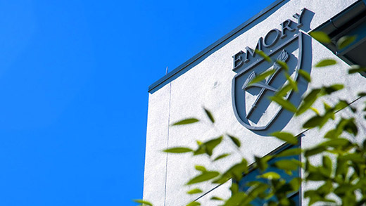 A close angle of the Emory University logo on the side of a building