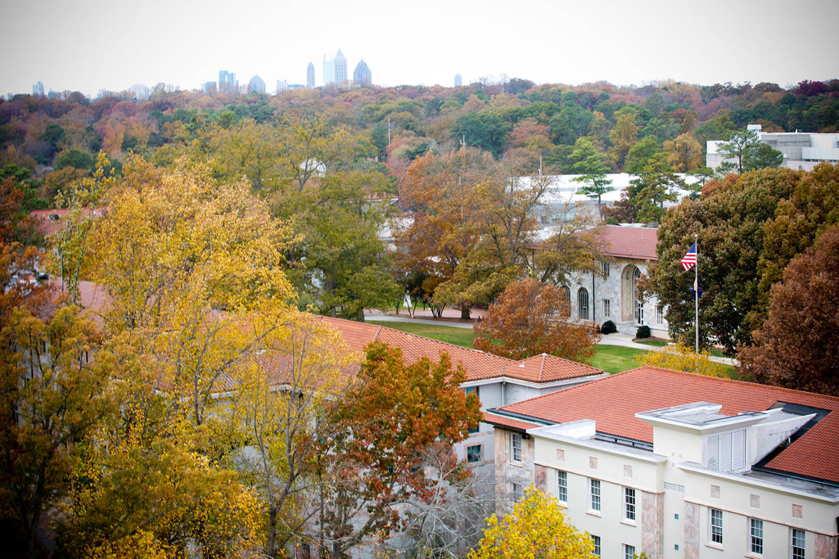 Emory University quad from the sky with fall leaves and Atlanta skyline in distance on a cloudy day