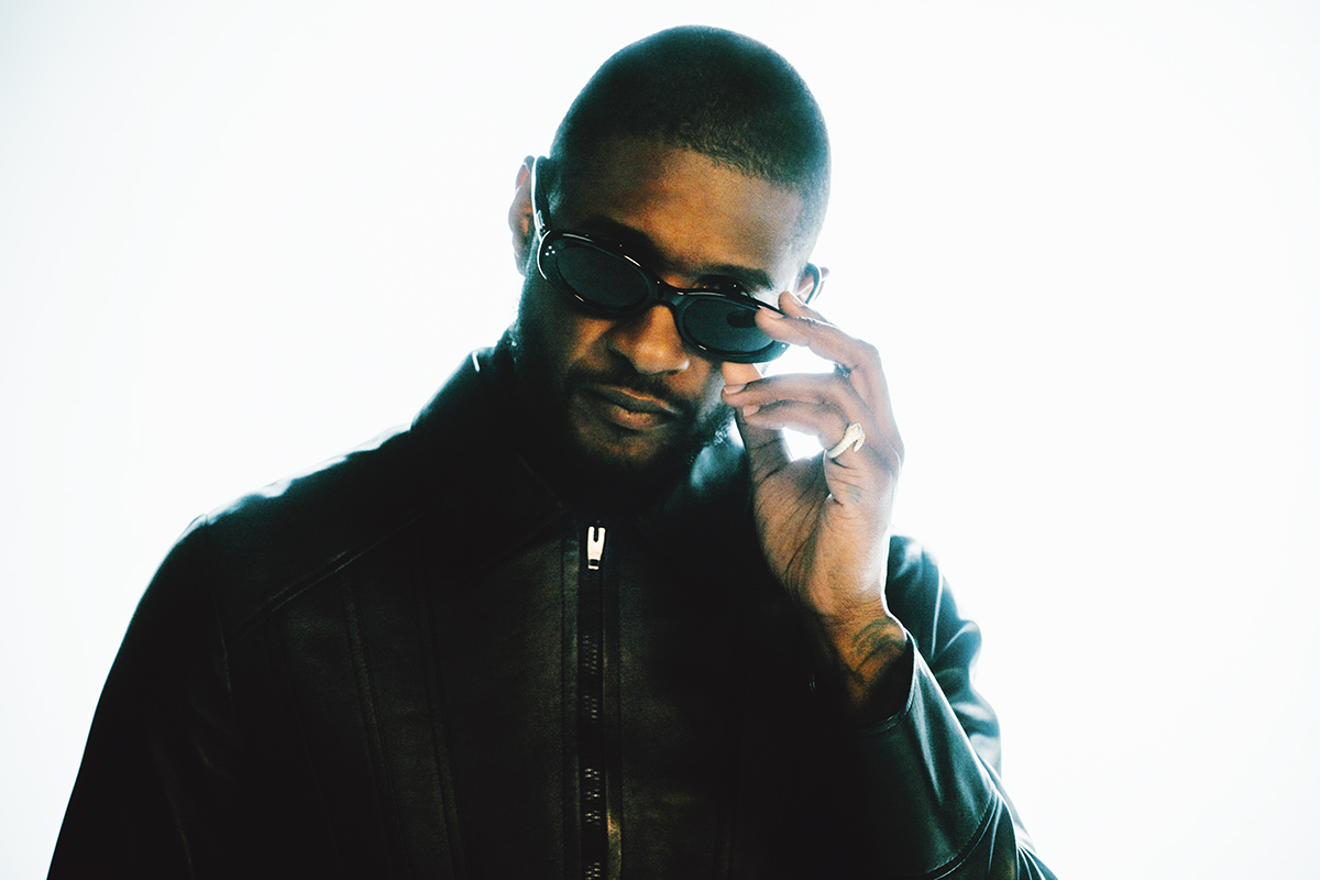 portrait of Usher Raymond IV wearing leather jacket and sunglasses