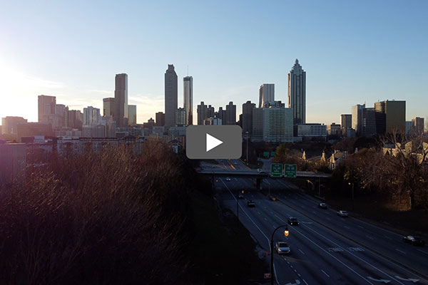 The Atlanta skyline with a button denoting that you can click to play a video